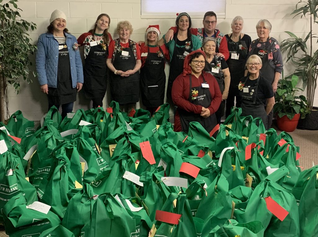 Storehouse volunteers with 60 food gift bags 